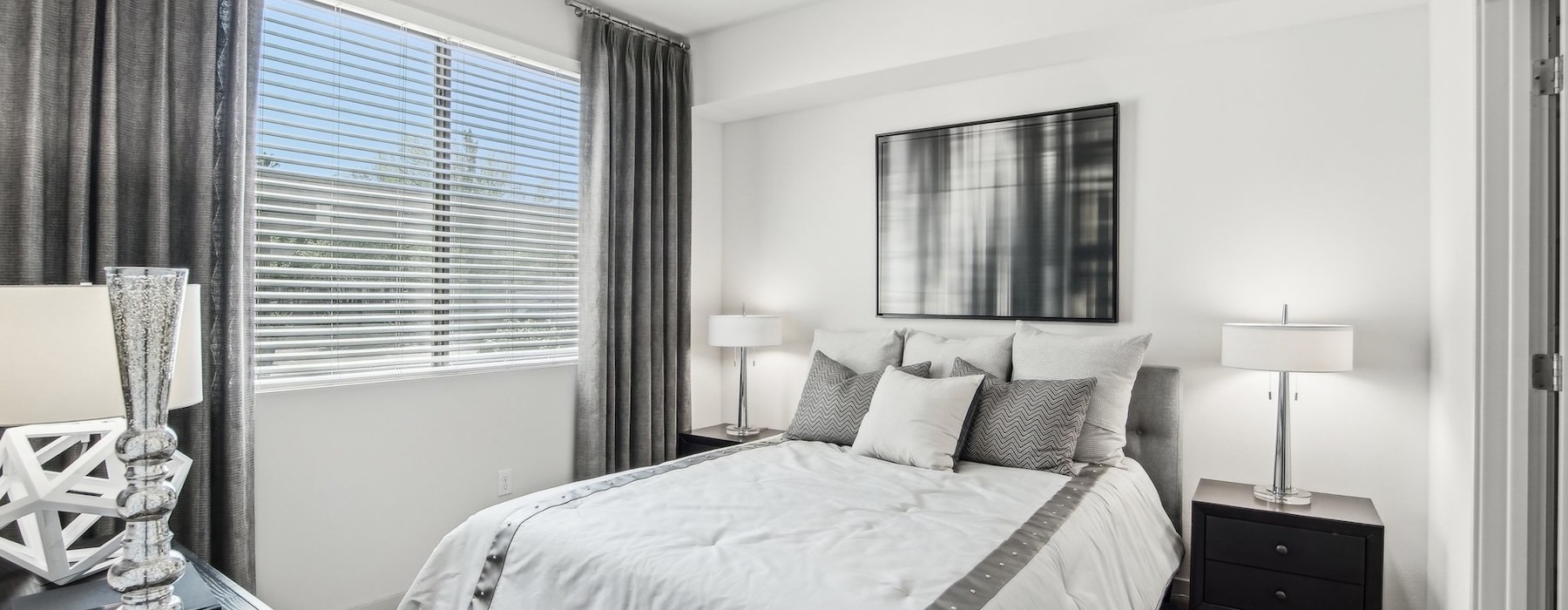 a bedroom with a bed and two nightstands