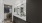 Large well lit bathroom with large mirror and brown cabinets 